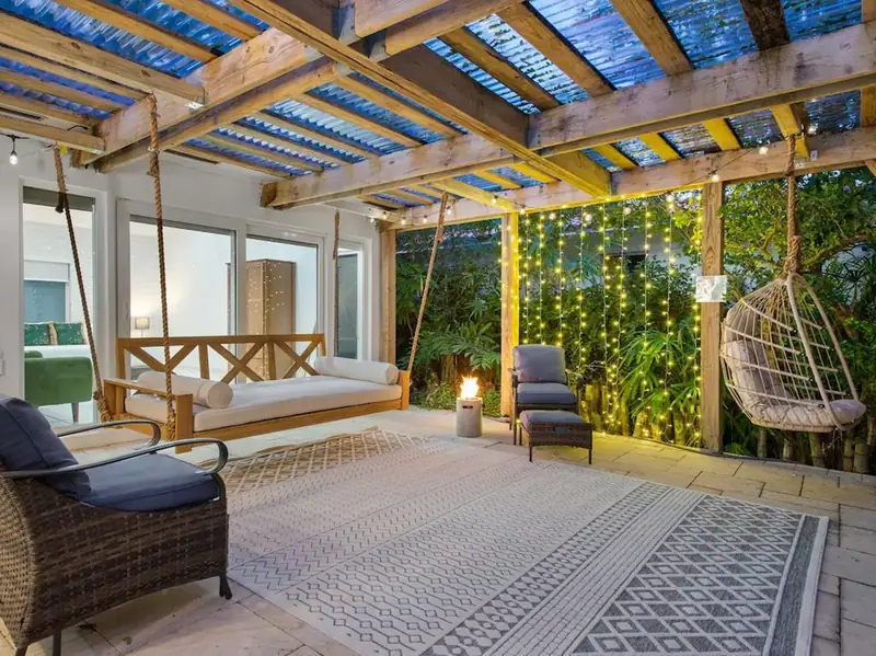 Covered patio with a porch swing and hanging chair