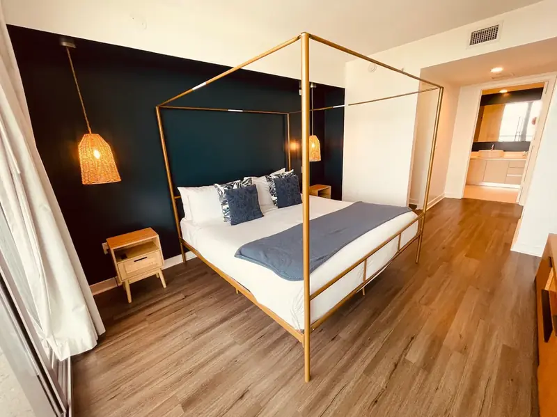 Bedroom with a canopy bed in the Beachwalk apartment