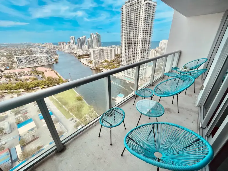 Balcony with turquoise chairs and a view over the Intracoastal and the ocean in Hallandale Beach
