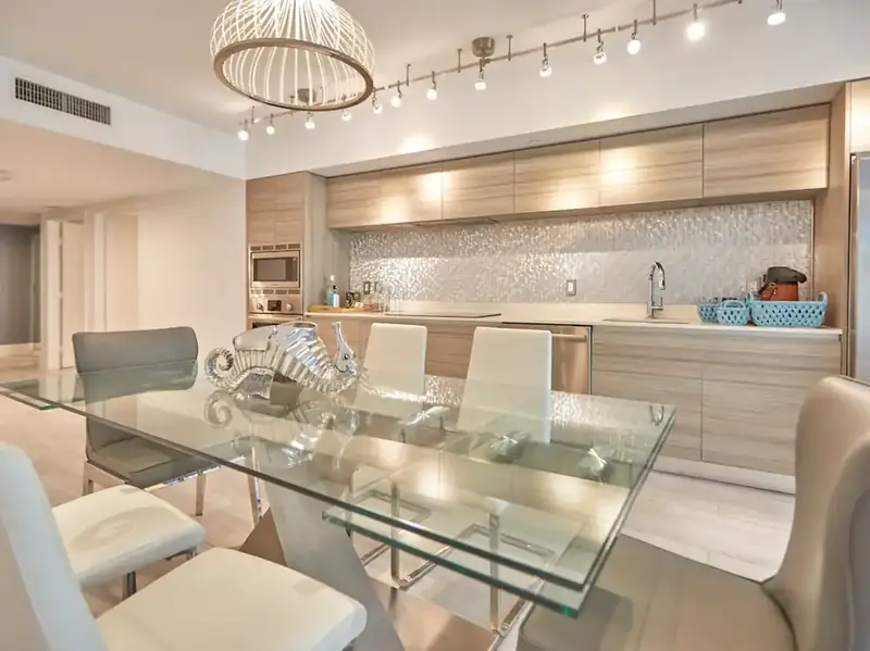 Dining table and modern kitchen in the Miami Beach apartment